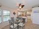 Cozy dining area with glass table, ceiling fan, and open access to the kitchen at 8439 Imperial Cir, Palmetto, FL 34221