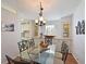 Dining room with glass table, lots of storage, and access to the kitchen at 8439 Imperial Cir, Palmetto, FL 34221