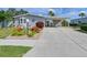Long driveway leads to a home with attractive landscaping, complete with a covered carport at 8439 Imperial Cir, Palmetto, FL 34221