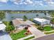 Beautiful waterfront property with well-maintained landscaping, blue siding, and covered parking at 8439 Imperial Cir, Palmetto, FL 34221