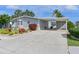 Front of home featuring a covered carport, beautiful landscaping, and view of the water at 8439 Imperial Cir, Palmetto, FL 34221