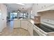 Galley-style kitchen with white appliances and cabinets, views of the water at 8439 Imperial Cir, Palmetto, FL 34221