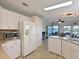 Bright kitchen with lots of light, views, white appliances, and laminate countertops at 8439 Imperial Cir, Palmetto, FL 34221