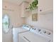 Laundry room with side-by-side washer and dryer, access to the backyard at 8439 Imperial Cir, Palmetto, FL 34221