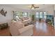 Inviting living room with lake views, comfortable furniture, and hardwood floors at 8439 Imperial Cir, Palmetto, FL 34221