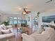 Bright living room with scenic lake views, cozy seating, and stylish decor at 8439 Imperial Cir, Palmetto, FL 34221