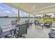 Covered patio with comfortable seating and serene water views for relaxing and entertaining at 8439 Imperial Cir, Palmetto, FL 34221