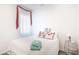 Bright, minimalist bedroom with neutral tones and decorative accents at 8445 Starlight Loop, Parrish, FL 34219