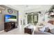Comfortable living area with a plush sofa, tile flooring, and a sliding glass door at 8445 Starlight Loop, Parrish, FL 34219