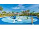 Community splash pad area with colorful features including palm trees on a clear, sunny day at 8445 Starlight Loop, Parrish, FL 34219