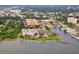 Expansive aerial view showcasing the waterfront condo community with stunning bay views and convenient parking at 1064 N Tamiami Trl # 1402, Sarasota, FL 34236