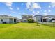 Large fenced backyard featuring green grass and neighboring homes at 11430 Gallatin Trl, Parrish, FL 34219