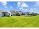 Expansive backyard featuring lush green grass and a black metal fence, perfect for outdoor activities at 11430 Gallatin Trl, Parrish, FL 34219