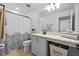 Well-lit bathroom featuring a shower-tub combo, patterned shower curtain, and spacious vanity with storage at 11430 Gallatin Trl, Parrish, FL 34219
