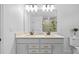 Modern bathroom featuring double sinks, sleek fixtures, a glass-enclosed shower, and neutral color palette at 11430 Gallatin Trl, Parrish, FL 34219