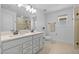 Elegant bathroom boasting double sinks, sleek fixtures, a glass-enclosed shower, and neutral color palette at 11430 Gallatin Trl, Parrish, FL 34219
