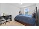 This cozy bedroom is carpeted and features a large window, desk, and blue-themed accents at 11430 Gallatin Trl, Parrish, FL 34219