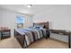 A bright bedroom features a striped bed, desk and light-colored carpet at 11430 Gallatin Trl, Parrish, FL 34219