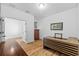 The spacious bedroom showcases wood floors, light walls, a wooden desk and a wooden cabinet at 11430 Gallatin Trl, Parrish, FL 34219