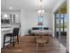 Dining area featuring a round wooden table and a modern chandelier, next to the kitchen at 11430 Gallatin Trl, Parrish, FL 34219