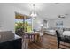 Open-concept kitchen, dining, and living space, with glass doors to an outdoor living area at 11430 Gallatin Trl, Parrish, FL 34219