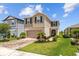 Charming two-story home features landscaped yard, brick driveway, and attached garage at 11430 Gallatin Trl, Parrish, FL 34219