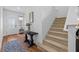 Entryway featuring wood floors, a modern table, and stairs leading to the upper level at 11430 Gallatin Trl, Parrish, FL 34219