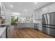 Modern kitchen with stainless steel appliances, hardwood floor and ample counter space at 11430 Gallatin Trl, Parrish, FL 34219