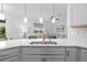 Beautiful kitchen features quartz counters, an undermount sink, stainless steel appliances, and views into the living room at 11430 Gallatin Trl, Parrish, FL 34219