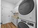 Well-equipped laundry room featuring stacked washer/dryer and butcher block folding counter at 11430 Gallatin Trl, Parrish, FL 34219