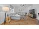 Open concept living room boasts a large gray sectional, wood floors, and contemporary decor at 11430 Gallatin Trl, Parrish, FL 34219