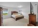 Spacious main bedroom featuring a king-size bed, with plenty of natural light and a lovely outside view at 11430 Gallatin Trl, Parrish, FL 34219
