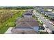 Aerial view of a well-maintained neighborhood featuring manicured lawns and a peaceful pond at 11430 Gallatin Trl, Parrish, FL 34219