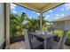 Covered patio seating area with wicker furniture and outdoor view at 11430 Gallatin Trl, Parrish, FL 34219