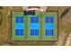 Aerial view of three tennis courts with a green and blue color scheme, surrounded by a black fence at 11430 Gallatin Trl, Parrish, FL 34219