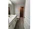 Bathroom featuring granite countertop, white cabinets and tiled shower at 12089 Mayfair Ave, Port Charlotte, FL 33981