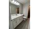 Modern bathroom boasts a marble countertop vanity, updated fixtures, and a tile floor at 12127 Storke Ave, Port Charlotte, FL 33981