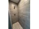The shower features stylish gray tiling with stone pebble accents on the floor and modern fixtures at 12127 Storke Ave, Port Charlotte, FL 33981