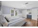 Bedroom features blue walls, wood floors, closet and a large window at 1507 45Th Avenue E Dr, Ellenton, FL 34222
