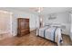Bedroom featuring wood floors, a bed, and a large dresser at 1507 45Th Avenue E Dr, Ellenton, FL 34222