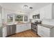 Kitchen with white cabinets, stainless appliances, granite counters, and bay window at 1507 45Th Avenue E Dr, Ellenton, FL 34222