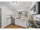 Well-lit kitchen with white cabinetry, stainless steel appliances, and ample counter space at 1507 45Th Avenue E Dr, Ellenton, FL 34222