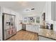 Bright kitchen featuring white cabinetry, stainless steel appliances, and granite countertops at 1507 45Th Avenue E Dr, Ellenton, FL 34222