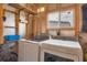 Practical laundry room with washer, dryer, shelving, and natural light, perfect for efficient chores at 1507 45Th Avenue E Dr, Ellenton, FL 34222