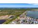 Aerial view of community with a house highlighted and the ocean in the background at 1657 Bonita Bluff Ct, Ruskin, FL 33570