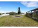 Expansive backyard featuring a fire pit, screened lanai, and fenced perimeter, perfect for outdoor gatherings at 1657 Bonita Bluff Ct, Ruskin, FL 33570