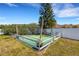 Backyard swing set and small area, fenced in with a white wooden fence at 1657 Bonita Bluff Ct, Ruskin, FL 33570