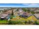 Aerial shot of backyard with screened pool, sports court, and cozy fire pit perfect for entertaining at 1657 Bonita Bluff Ct, Ruskin, FL 33570