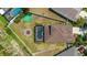 Aerial view of fenced in backyard, featuring a sparkling pool, sport court, and outdoor space at 1657 Bonita Bluff Ct, Ruskin, FL 33570