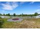 Spacious backyard with a unique fire pit area, enclosed by a white fence, offering privacy and relaxation at 1657 Bonita Bluff Ct, Ruskin, FL 33570